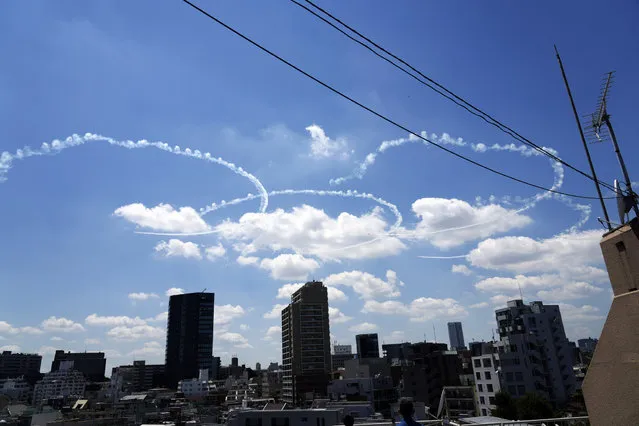 Blue Impulse of the Japan Air Self-Defense Force draws the Olympic Rings Wednesday, July 21, 2021, in the skies over Tokyo. Japan will host the Tokyo 2020 Olympics starting July 23. (Photo by Eugene Hoshiko/AP Photo)