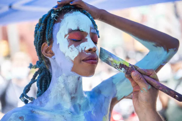 McKensi Pascall is painted by artist Tom Sebazco at Human Connection Arts 8th Annual NYC Body Painting Day in Union Square Park on Sunday, July 25, 2021 in New York. (Photo by Brittainy Newman/AP Photo)