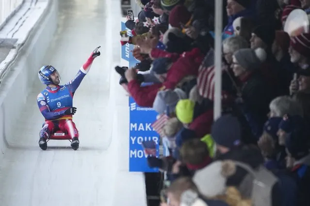 Chris Mazdzer, of the United States, gestures to the crowd in the finish area at the World Cup luge event in Lake Placid, N.Y., Friday, December 8, 2023. Mazdzer announced that he is retiring after this event. (Photo by Seth Wenig/AP Photo)