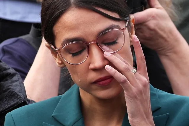 U.S. Representative Alexandria Ocasio-Cortez (D-NY) wipes away tears as Representative Ilhan Omar (D-MN) talks about her own experience as a refugee during a news conference to call on Congress to cut funding for ICE (Immigration and Customs Enforcement), at the U.S. Capitol in Washington, U.S. February 7, 2019. (Photo by Jonathan Ernst/Reuters)