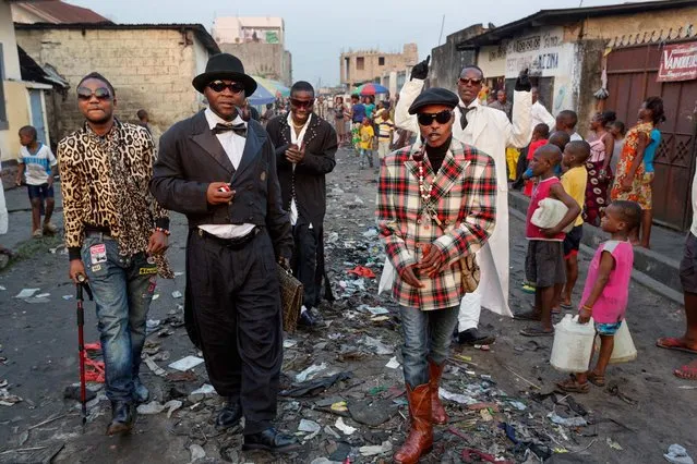Luxury and adversity mingle in this dichotomous image made by Pascal Maitre. The opulent ensembles these men style look out of place in the littered streets of Kinshasa. For Les Sapeurs, members of the Société des Ambianceurs et des Personnes Elégantes (the Society of Tastemakers and Elegant People), their clothes are as much about extravagance as they are about creativity. But beyond being a form of self-expression, it is a lifestyle about poise and propriety. (Photo by Pascal Maitre/National Geographic)