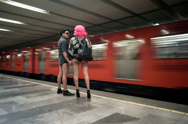 People taking part in the “No Pants Subway Ride” wait at a metro station in Mexico City on January 12, 2014. (Photo by Antonio Nava/AFP Photo)