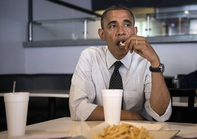 US President Barack Obama eats a french fry while meeting with supporters about voter registration at OMG Burgers on September 20, 2012 in Miami, Florida. (Photo by Brendan Smialowski/AFP Photo)