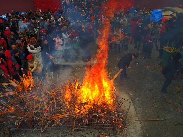 People pray with incense sticks at a temple fair as they celebrate the Lunar New Year in Shenyang, Liaoning province, China, January 28, 2017. (Photo by Sheng Li/Reuters)