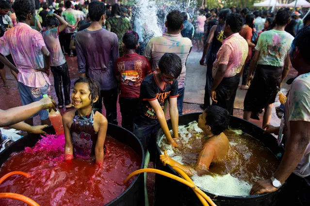 Myanmar's Hindu children soak in a pool of coloured water as they celebrate the Holi festival in Yangon on March 20, 2019. (Photo by Sai Aung Main/AFP Photo)