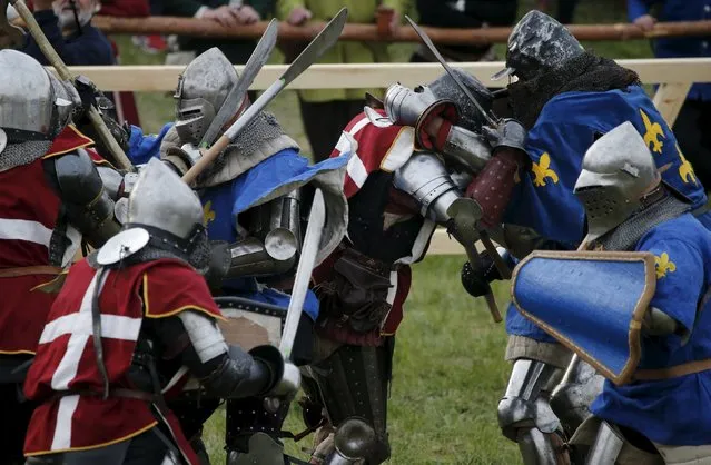 Fighters from France compete against their opponents from Denmark during their “5 vs 5” competition at the Medieval Combat World Championship at Malbork Castle, northern Poland, April 30, 2015. (Photo by Kacper Pempel/Reuters)