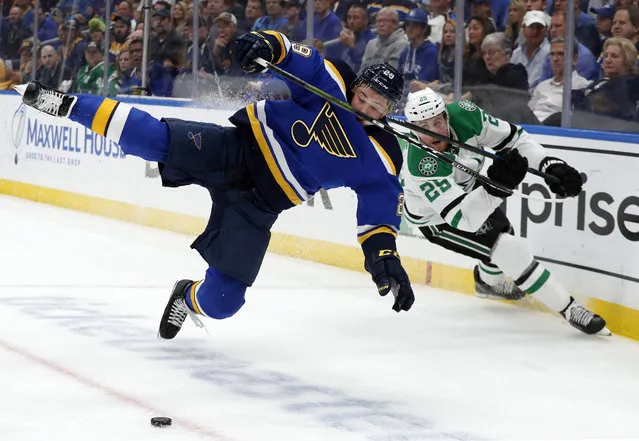 St. Louis Blues defenseman Vince Dunn (29) and Dallas Stars right wing Brett Ritchie (25) compete for control of a loose puck during the first period in Game 7 of an NHL second-round hockey playoff series, Tuesday, May 7, 2019, in St. Louis. (Photo by Jeff Roberson/AP Photo)