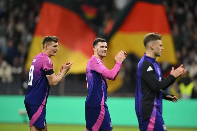 (L-R) Germany's midfielder #08 Toni Kroos, Germany's midfielder #05 Pascal Gross and Germany's midfielder #06 Joshua Kimmich clap hands to celebrate after winning the friendly football match between Germany and Netherlands in Frankfurt, western Germany, on March 26, 2024. (Photo by Ina Fassbender/AFP Photo)