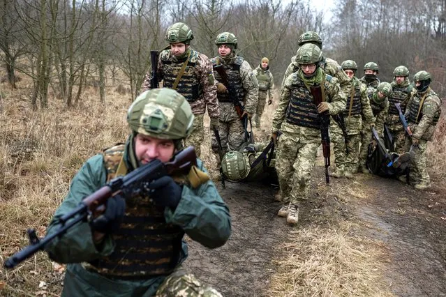 New recruits of the 1st Da Vinci Wolves Separate Mechanized Battalion, named after Dmytro Kotsiubailo, attend a military exercise in an undisclosed location, in Central Ukraine on March 12, 2024. (Photo by Viacheslav Ratynskyi/Reuters)