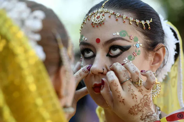 A Lord Krishna devotee is made up before the start of the Festival of Chariots, Ratha-yatra, held by the community of the Krishna Consciousness to honour Jagannatha, the Lord of the Universe, in Budapest, Hungary, Saturday, June 29, 2019. (Photo by Szilard Koszticsak/MTI via AP Photo)