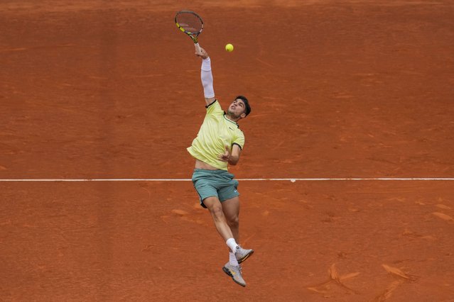 Carlos Alcaraz, of Spain, returns the ball to Thiago Seyboth Wild, of Brazil, during the Mutua Madrid Open tennis tournament in Madrid, Sunday, April 28, 2024. (Photo by Manu Fernandez/AP Photo)