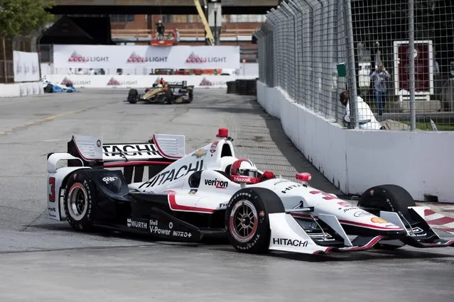 Helio Castroneves, of Brazil, enters a corner during practice for the IndyCar auto race Saturday, June 13, 2015, in Toronto. (Aaron Vincent Elkaim/The Canadian Press via AP)