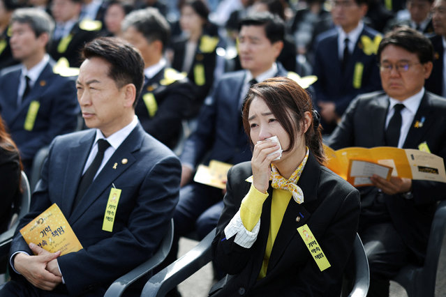 A woman reacts during a ceremony to commemorate the tenth anniversary of the sunken Sewol ferry disaster that killed 304 people, mostly school students, in Ansan, South Korea, on April 16, 2024. (Photo by Kim Hong-Ji/Reuters)