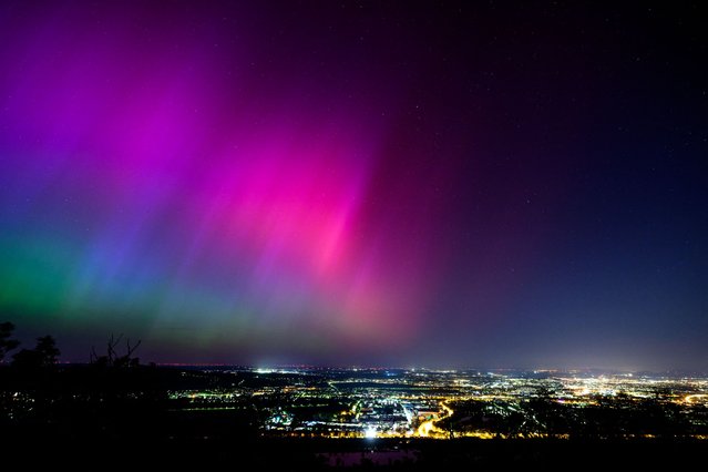 Northern lights or aurora borealis illuminate the night sky over Vienna during a geomagnetic storm on May 11, 2024. The planet is experiencing its first “extreme” geomagnetic storm since 2003, a US agency said on Mai 10, 2024. (Photo by Max Slovencik/APA via AFP Photo)