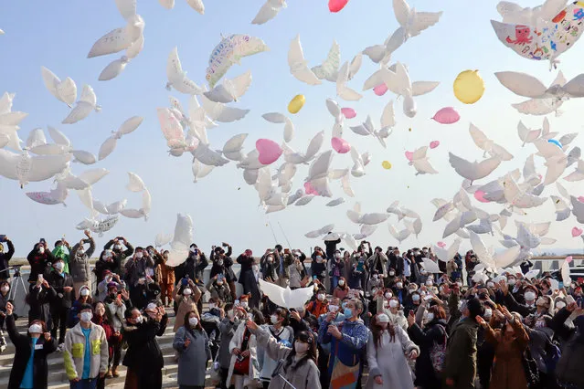 People release balloons with messages for the victims of the devastating 2011 earthquake and tsunami in Natori, Miyagi prefecture, northeastern Japan, 11 March 2021. Japan is commemorating the 10th anniversary of the Great East Japan Earthquake and subsequent tsunami in which approximately 20,000 people lost their lives on 11 March 2011. (Photo by JIJI Press/EPA/EFE)