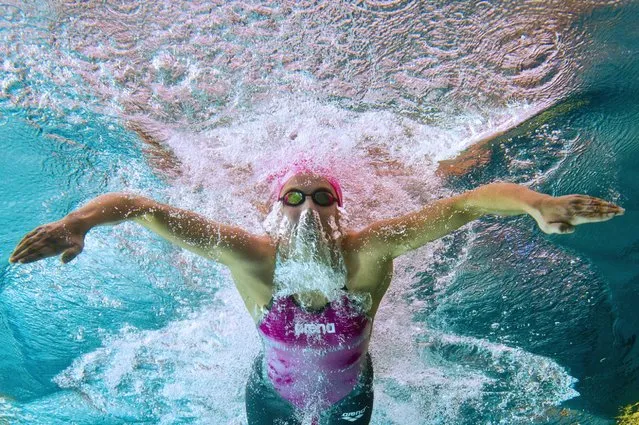 This picture, taken with an underwater camera, shows Charlotte Bonnet competing in the 100m breaststroke semi-final, April 9, 2014, during the French swimming championships in Chartres. (Photo by Damien Meyer/AFP Photo)