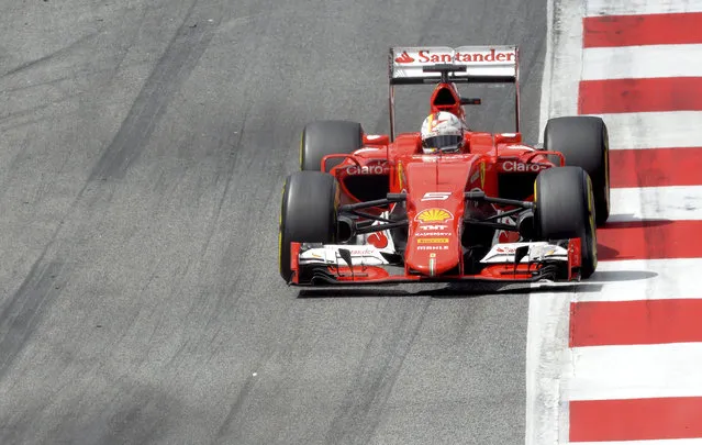 Fourth placed Ferrari driver Sebastian Vettel of Germany steers his car during the Austrian Formula One Grand Prix race at the Red Bull Ring  in Spielberg, southern Austria, Sunday, June 21, 2015. (AP Photo/Kerstin Joensson)