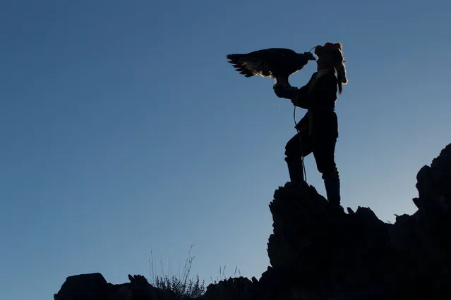 13 year old Ashol Pan with her eagle – Despite her young age, Ashol had the amazing ability to control and be able to caress her eagle, almost as if she had been with it for years. (Photo by Asher Svidensky/Caters News)