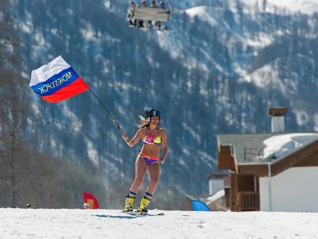 A girl dressed in a swimsuit participates in the BoogelWoogel alpine carnival at the Rosa Khutor Alpine Resort in Krasnaya Polyana, Sochi, Russia on April 1, 2017. (Photo by Artur Lebedev/TASS)
