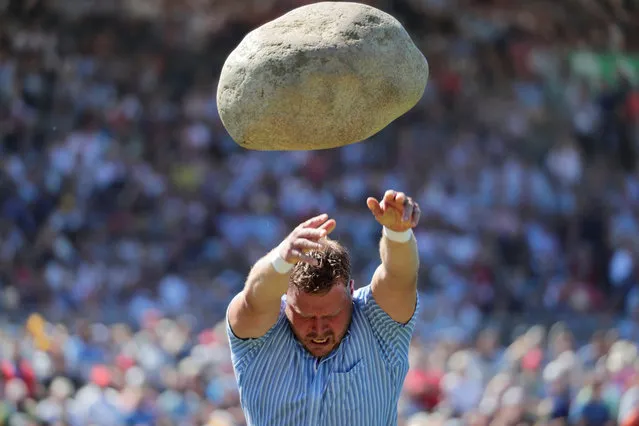 Martin Jakober throws the 83.5kg Unspunnen stone during the ESAF-Federal Alpine Wrestling Festival (Eidgenoessisches Schwing- und Aelplerfest) in Zug, Switzerland, August 25, 2019. (Photo by Moritz Hager/Reuters)