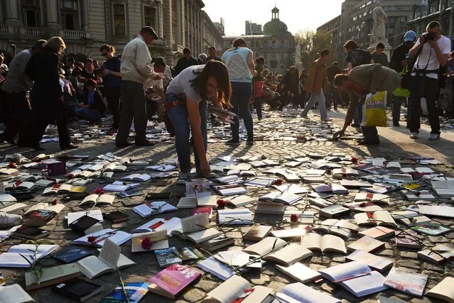 People collect free books offered by a publishing house on International Book Day in Bucharest, Romania on April 23, 2014. (Photo by Daniel Mihailescu/AFP Photo)