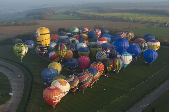 Some of the 100 balloons taking part in a World Record attempt for a mass hot air balloon crossing of the English Channel prepare for take off near Dover England Friday April 7, 2017. (Photo by Victoria Jones/PA Wire via AP Photo)