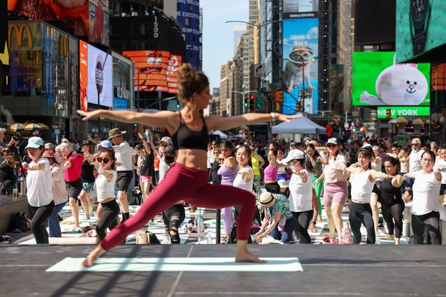 Yogi Cealia Brannan teaches a free yoga class to celebrate the Summer Solstice, called “Solstice in Times Square: Mind Over Madness Yoga”, at Times Square in New York, New York, USA, 20 June 2024. (Photo by Sarah Yenesel/EPA/EFE)