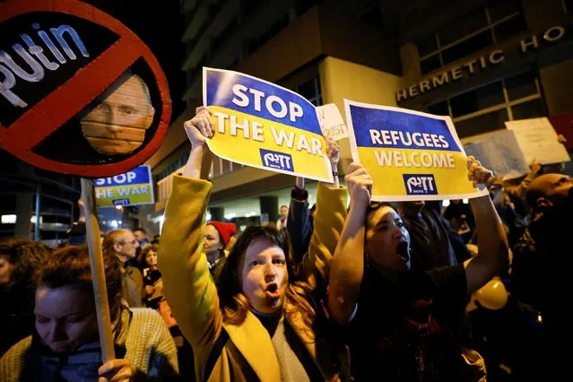 Protestors hold signs at a demonstration against the Russian military invasion into Ukraine, calling on President Vladimir Putin to stop the war, outside the Russian Embassy in Tel Aviv, Israel on March 5, 2022. (Photo by Ammar Awad/Reuters)
