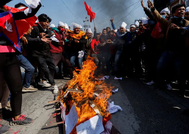 Protesters cremate a dummy corpse representing a U.S infrastructure grant before cremating it during a protest against the $500 million U.S infrastructure grant under the Millennium Challenge Corporation (MCC) near the parliament in Kathmandu, Nepal on February 18, 2022. (Photo by Navesh Chitrakar/Reuters)
