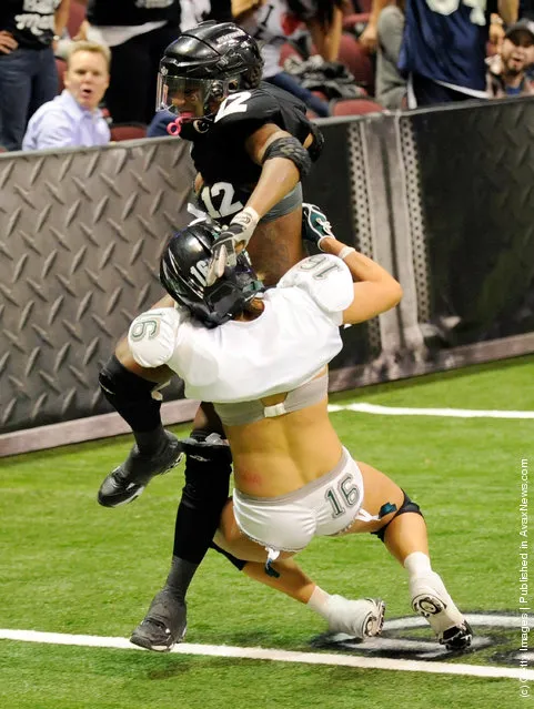 Danielle Harvey #12 of the Los Angeles Temptation scores a touchdown against Whitney Paronish #16 of the Philadelphia Passion during the Lingerie Football League's Lingerie Bowl IX at the Orleans Arena