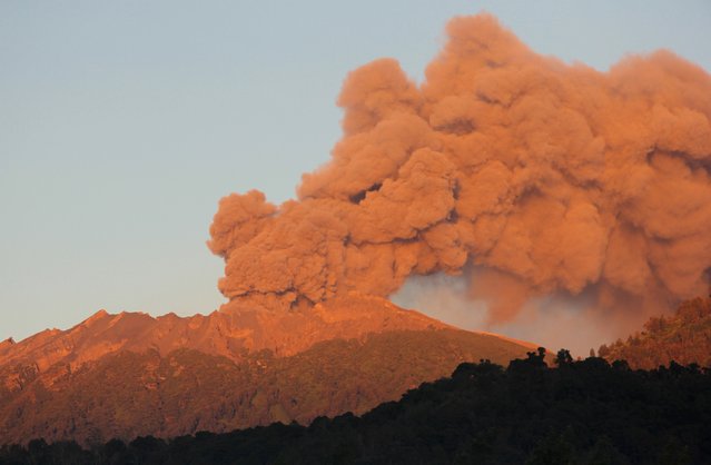 Mount Raung volcano emits huge clouds of ash and gas as seen early on July 17, 2015 from Jampit village in Bondowoso located in eastern Java island. Thousands of Indonesians were spending a miserable Eid Friday after failing to make it home to see their families after erupting volcanoes closed six airports, including in the country's second-biggest city. (Photo by AFP Photo/Widarsha)