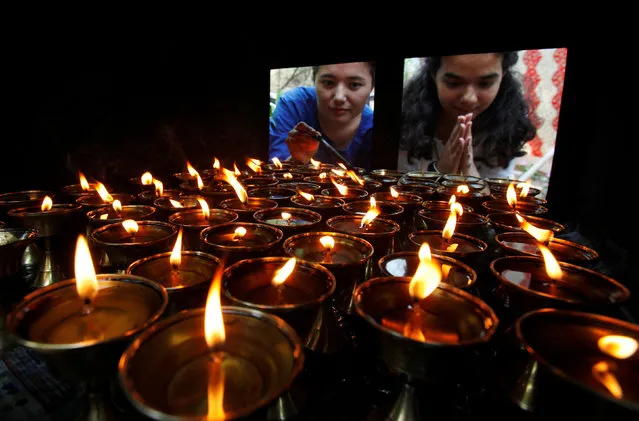 Devotees offer prayers next to oil lamps at a Buddhist temple on the occasion of Buddha Purnima festival, also known as Vesak Day, in Chandigarh, India, May 10, 2017. (Photo by Ajay Verma/Reuters)