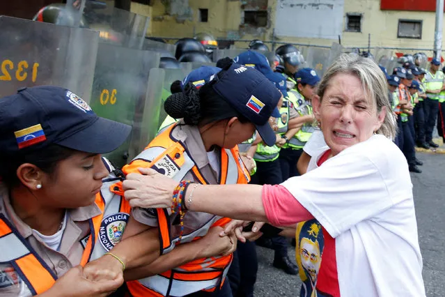 A woman reacts after riot police used pepper spray during a protest against Venezuela's President Nicolas Maduro's government in Caracas, Venezuela on April 1, 2017. (Photo by Carlos Garcia Rawlins/Reuters)