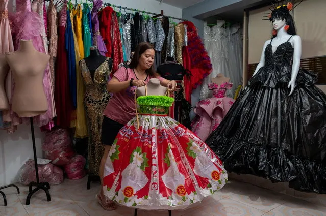 Nora Buenviaje displays a dress made of used sacks of rice and plastic bags, at her shop in Cainta, Rizal Province, Philippines, March 3, 2022. (Photo by Lisa Marie David/Reuters)