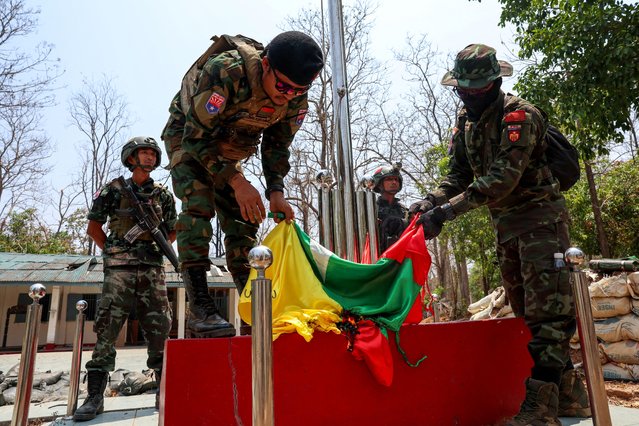 LT Saw Kaw, a soldier of the Karen National Liberation Army (KNLA) in charge of the Cobra column, burns Myanmar's national flag at a Myanmar military base at Thingyan Nyi Naung village on the outskirts of Myawaddy, the Thailand-Myanmar border town under the control of a coalition of rebel forces led by the Karen National Union, in Myanmar, on April 15, 2024. (Photo by Athit Perawongmetha/Reuters)