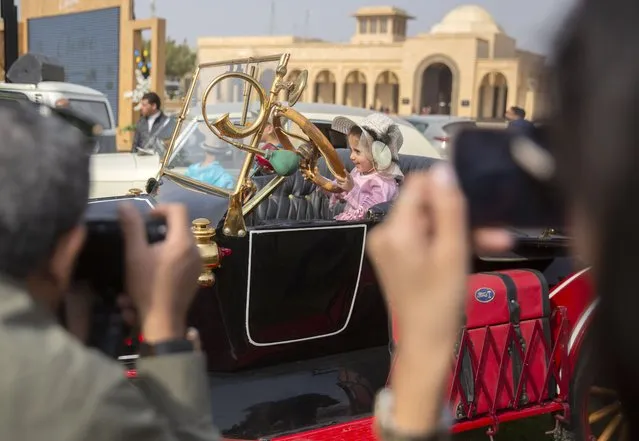 Five-year-old Samar sits for a photo in a 1924 Ford T owned by Egyptian collector Mohamed Wahdan during a classic car show in Cairo, Egypt, Saturday, March 19, 2022. The car once belonged to Egypt's King Farouk's and is a part of over 250 vintage, antique and classic cars Wahdan collected over the past 20 years. (Photo by Amr Nabil/AP Photo)