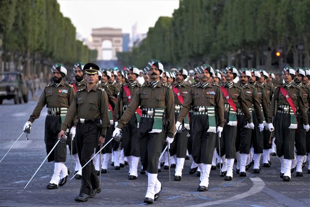 Indian soldiers march on the Champs Elysees avenue during a rehearsal for the Bastille Day parade in Paris, France, Monday, July 10, 2023. (Photo by Christophe Ena/AP Photo)