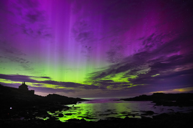 The aurora borealis, also known as the northern lights, fill the sky over The Bathing House in Howick, Northumberland on Monday night and into the early hours of Tuesday, August 13, 2024. (Photo by Owen Humphreys/PA Images via Getty Images)