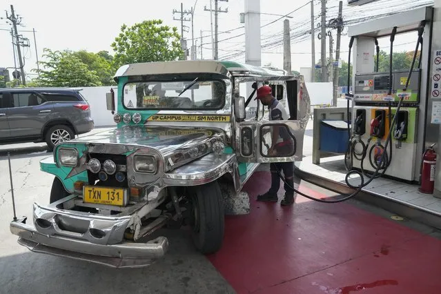 A passenger jeepney driver refuels his vehicle at a gasoline station in Quezon City, Philippines on Monday, June 20, 2022. Around the world, drivers are looking at numbers on the gas pump and rethinking their habits and finances. (Photo by Aaron Favila/AP Photo)