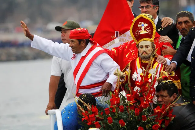 Peruvians commemorate the Day of the Fisherman by taking a statue of Saint Peter out on a boat along the coast in Lima June 29, 2016. (Photo by Guadalupe Pardo/Reuters)