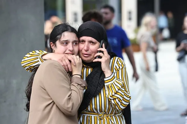 People are seen during the evacuation of the Fields shopping center in Copenhagen, Denmark, on July 3, 2022 after Danish media reported a shooting. (Photo by Olafur Steinar Gestsson/Ritzau Scanpix via AFP Photo)