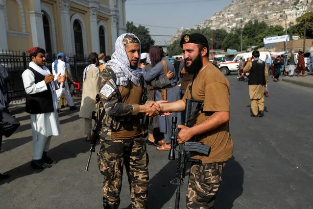 Taliban fighters greet each other outside the Shah-e Doh Shamshira Mosque, on the first day of Eid al-Adha, in Kabul, Afghanistan, July 9, 2022. (Photo by Ali Khara/Reuters)