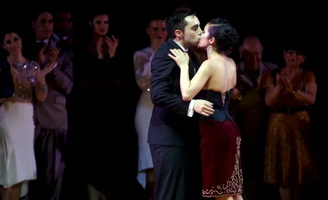 Jonathan Saavedra (C) and Clarisa Aragon from Argentina, representing the Argentine city of Cordoba, kiss after winning the Tango World Championship in Salon style, in Buenos Aires August 26, 2015. (Photo by Marcos Brindicci/Reuters)