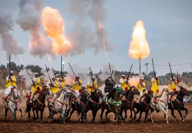 Moroccan horsemen perform traditional horse riding during a Moussem culture and heritage festival in the capital Rabat, on August 27,2022. (Photo by Fadel Senna/AFP Photo)