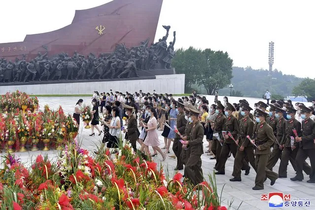 In this photo provided by the North Korean government, people and military personnel visit the statues of former North Korean leaders Kim Il Sung and Kim Jong Il on Mansu Hill in Pyongyang, North Korea, Wednesday, July 27, 2022, on the occasion of the 69th anniversary of the end of the Korean War. (Photo by Korean Central News Agency/Korea News Service via AP Photo)