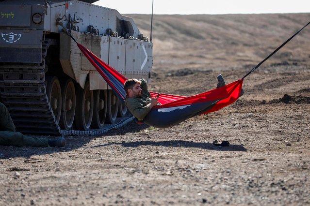 An Israeli solider takes a break during a drill in the annexed Golan Heights on November 9, 2023, amid increasing cross-border tensions between Hezbollah and Israel as fighting continues in the south with Hamas militants in the Gaza Strip. (Photo by Jalaa Marey/AFP Photo)