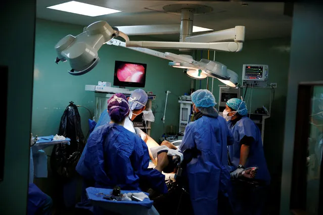 Surgeons carry out a sterilization on a patient in an operating room at a hospital in Caracas, Venezuela July 27, 2016. (Photo by Carlos Garcia Rawlins/Reuters)