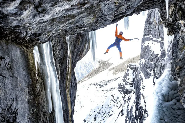 In this image released on Thursday, October 12, 2017, Mammut Pro Team Alpine athlete Dani Arnold traverses a section of the Breitwangflue near Kandersteg in Switzerland. Arnold was wearing the Nordwand Pro HS Suit, part of the newly released Eiger Extreme Collection from Mammut. (Photo by Thomas Senf/Mammut via AP Images)