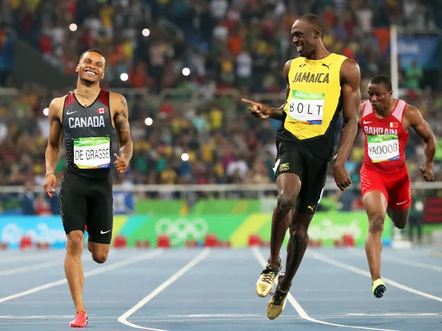 Andre de Grasse (L) of Canada and Usain Bolt (C) of Jamaica react after competing during the men's 200m semi finals of the Rio 2016 Olympic Games Athletics, Track and Field events at the Olympic Stadium in Rio de Janeiro, Brazil, 17 August 2016. (Photo by Srdjan Suki/EPA)