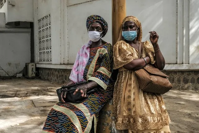 Women wearing face masks wait for a taxi in Dakar, Senegal, May 12, 2020. Senegal on Wednesday reported 110 new confirmed cases of COVID-19, bringing the total number to 2,105 in the country. (Photo by Xinhua News Agency/Rex Features/Shutterstock)